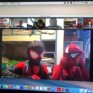 Two kids dressed as Spiderman and venom as they participate in French activities online.